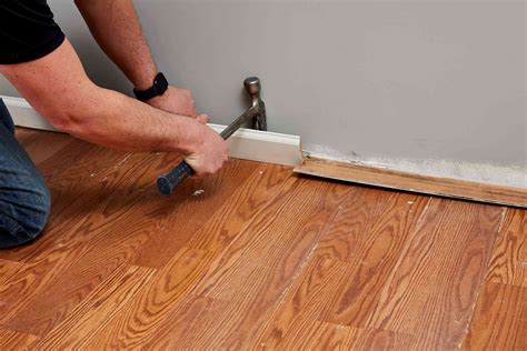 How To Install Laminate Flooring in 12 Steps: Cover the subfloor with a foam pad; staple the pad in place with a hammer tacker. Set first plank in place with the tongue edge facing the wall or baseboard molding. Tap together the planks in the first row, end to end. Be sure to use a tapping block to prevent damaging the flooring.